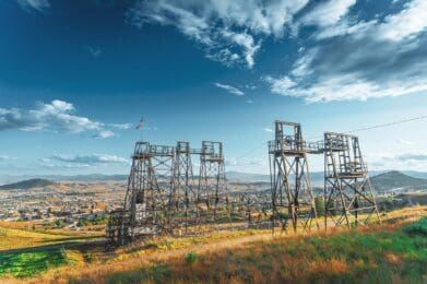 A group of power lines sitting on top of a lush green hillside